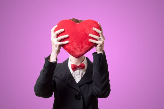 elegant businesswoman with heart pillow on pink background