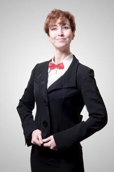 elegant businesswoman with bow tie on gray background