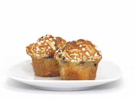 blueberry muffins with almond toppings on plate