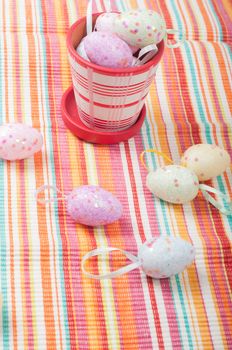 Easter eggs and striped napkin with flowerpot