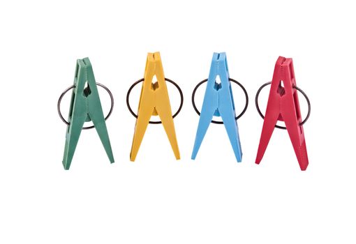 Closeup of four multi-colored plastic clothespegs located vertically. Image is isolated on white and the file includes a clipping path.