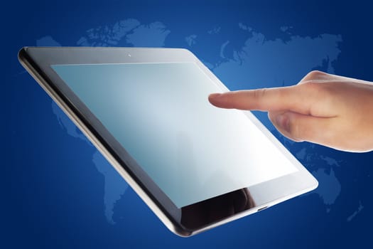 tablet computer and a hand on blue background with world map
