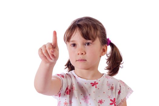 Cute little girl drawing in the air with her finger