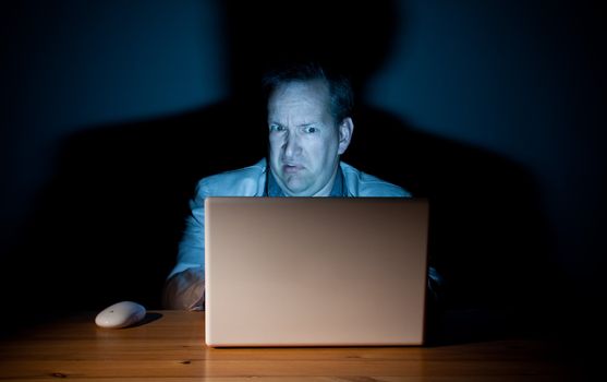 Man looking disgusted in front of his computer