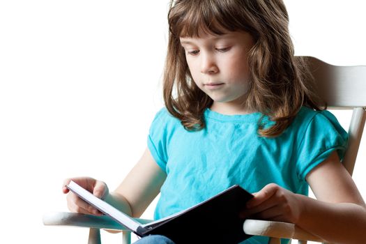 Cute little girl sitting and reading