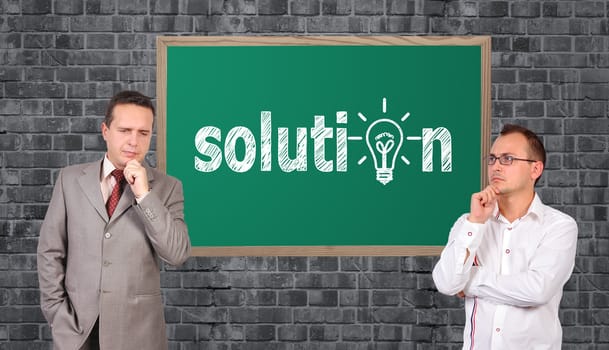 two businessman and solution symbol on board