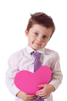 Cute little boy holding a pink cardboard heart