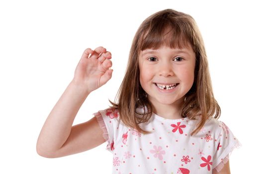 Cute little girl showing the first tooth she lost