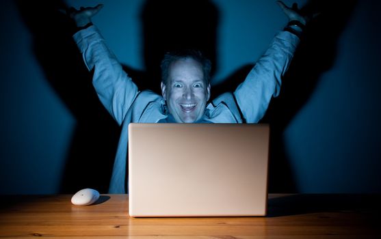 Man looking happy in front of his computer