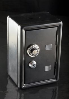 Entire view of a black strongbox over black background