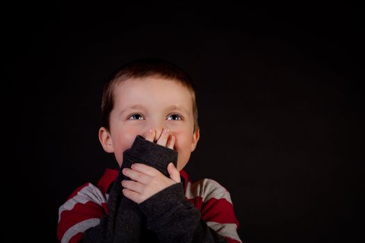 Shy little boy laughing