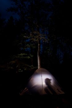 Camping in a tent with a light on