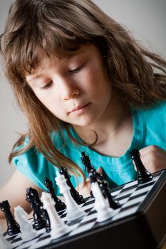 Cute little girl playing chess