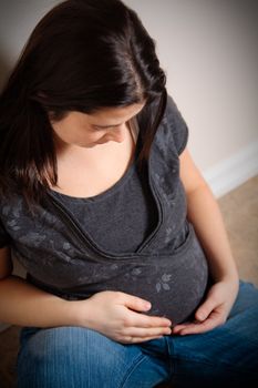 18 weeks pregnant woman sitting on the floor