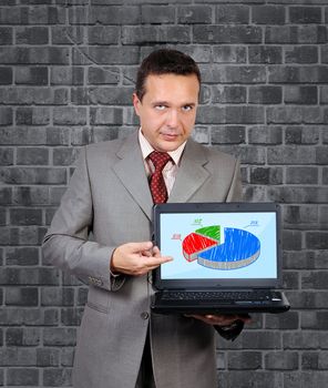 man with a laptop in hand points to business strategy