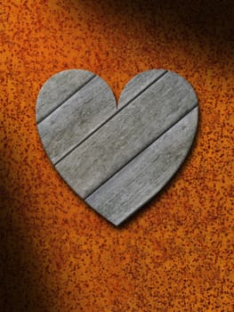 Weathered gray wood heart against rusty orange metal background