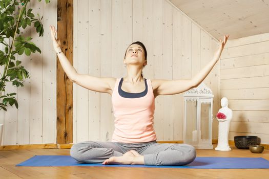 An image of a pretty woman doing yoga at home -