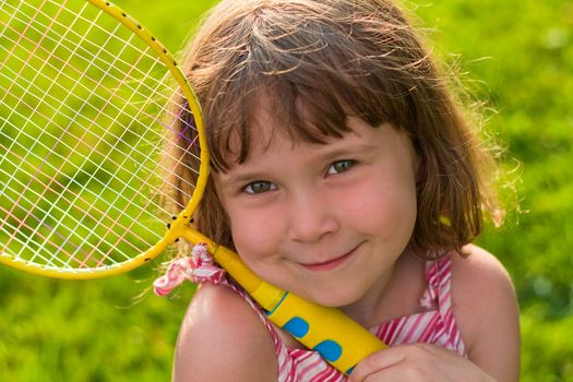 Cute little girl holding a badminton racket