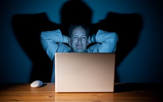 Man looking content in front of his computer