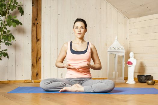 An image of a pretty woman doing yoga at home -