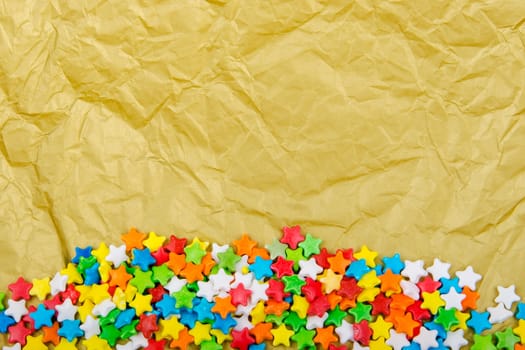 Multicolored stars on a background of crumpled paper