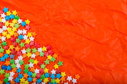 Multicolored stars on a background of crumpled paper