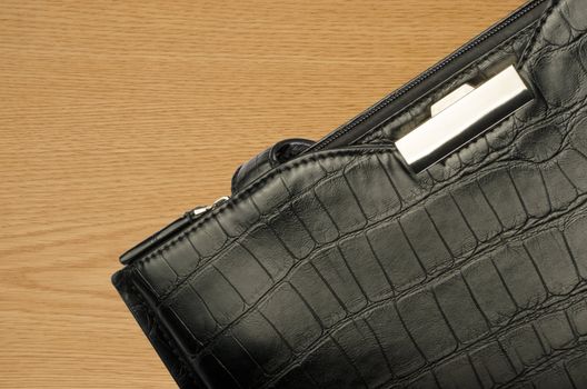 A black business bag on a wooden background