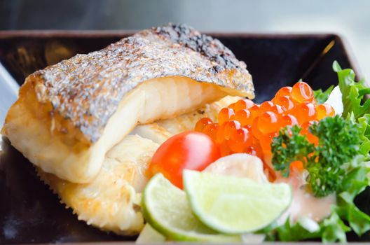 fresh salad with fish egg  and Japanese grilled cod fish  on plate