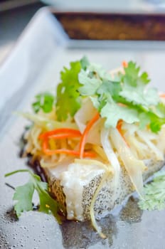 steamed white fish fillet with  vegetable  on the plate