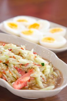 spicy cucumber  salad served with slices of  boiled egg