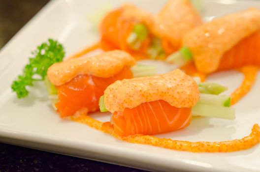 close up salmon rolls with vegetable on  plate  , seafood dish