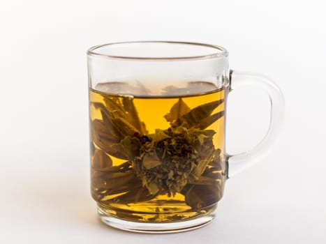 flower bloomed in a glass of green tea