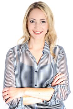 Happy confident blonde woman with a radiant smile and arms folded standing on a white studio background Happy confident blonde woman with a radiant smile and arms folded standing on a white studio background