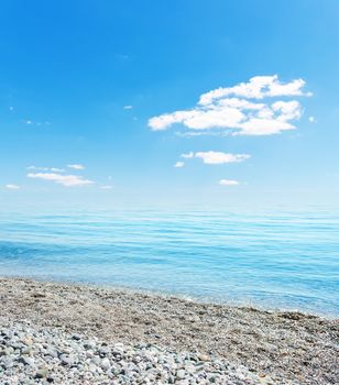 stones on beach, sea and blue sky. Crimea, Ukraine