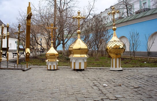 Gold cupolas and orthodox cross, St. Michael monastery in Kiev
