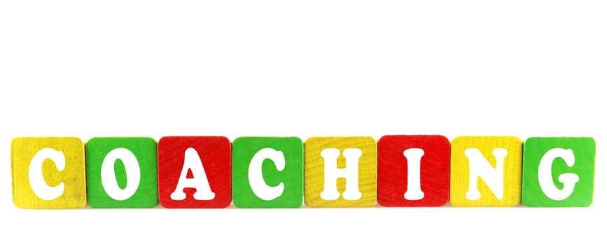 coaching - isolated text in wooden building blocks