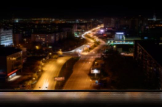 view from the window of the city at night, illuminated by light from the window sill windows