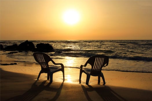 two empty chairs on the beach waiting for lovers, that would carry out the sunset