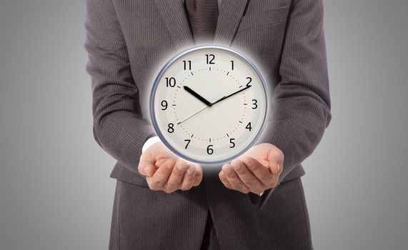 business man with wall clock on his hand, grey background