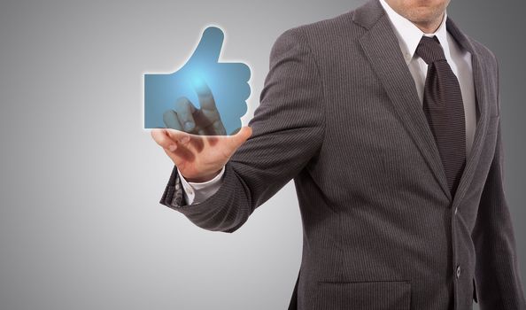 Businessman Presses a Like Button, grey background