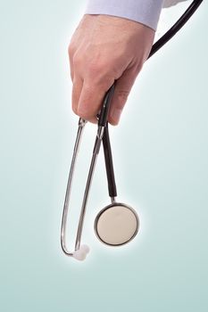 doctor holding stethoscope, closeup on strument