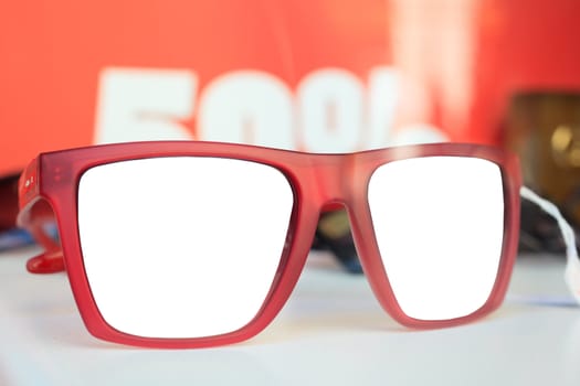 Photo of red glasses on white surface