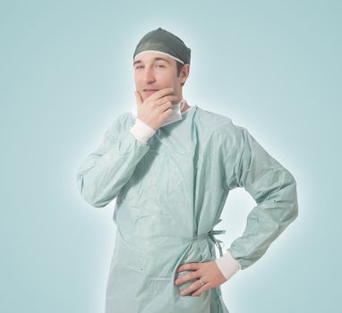 young male surgeon isolated on green feathered background