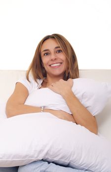 smiling young woman embracing cushion pillow