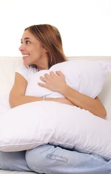 mature lady cuddling a pillow on couch