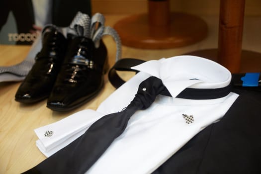 Black Shoes and black necktie on a white elegant shirt