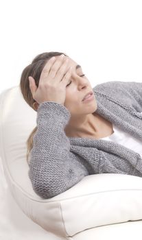 Woman having head ache holding hand on forehead.