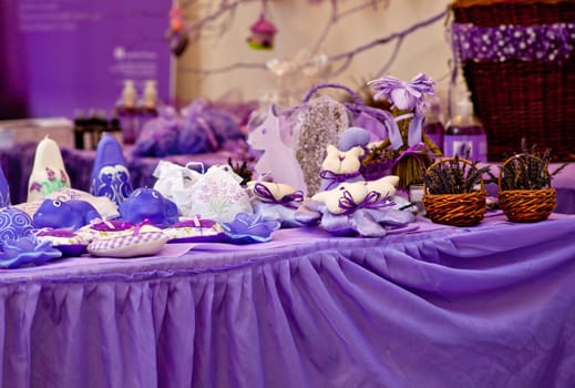 Candles and other object in a purple stand