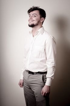 stylish modern guy with white shirt on gray background