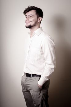 stylish modern guy with white shirt on gray background